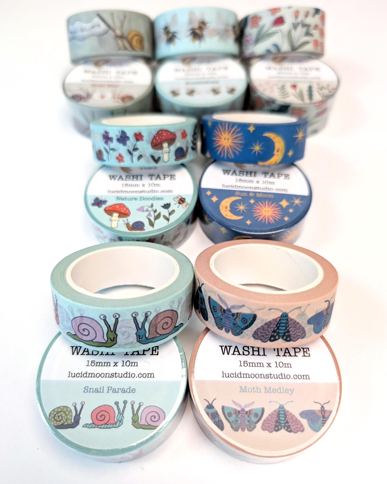 An assortment of colorful nature-inspired washi tape rolls on a white background