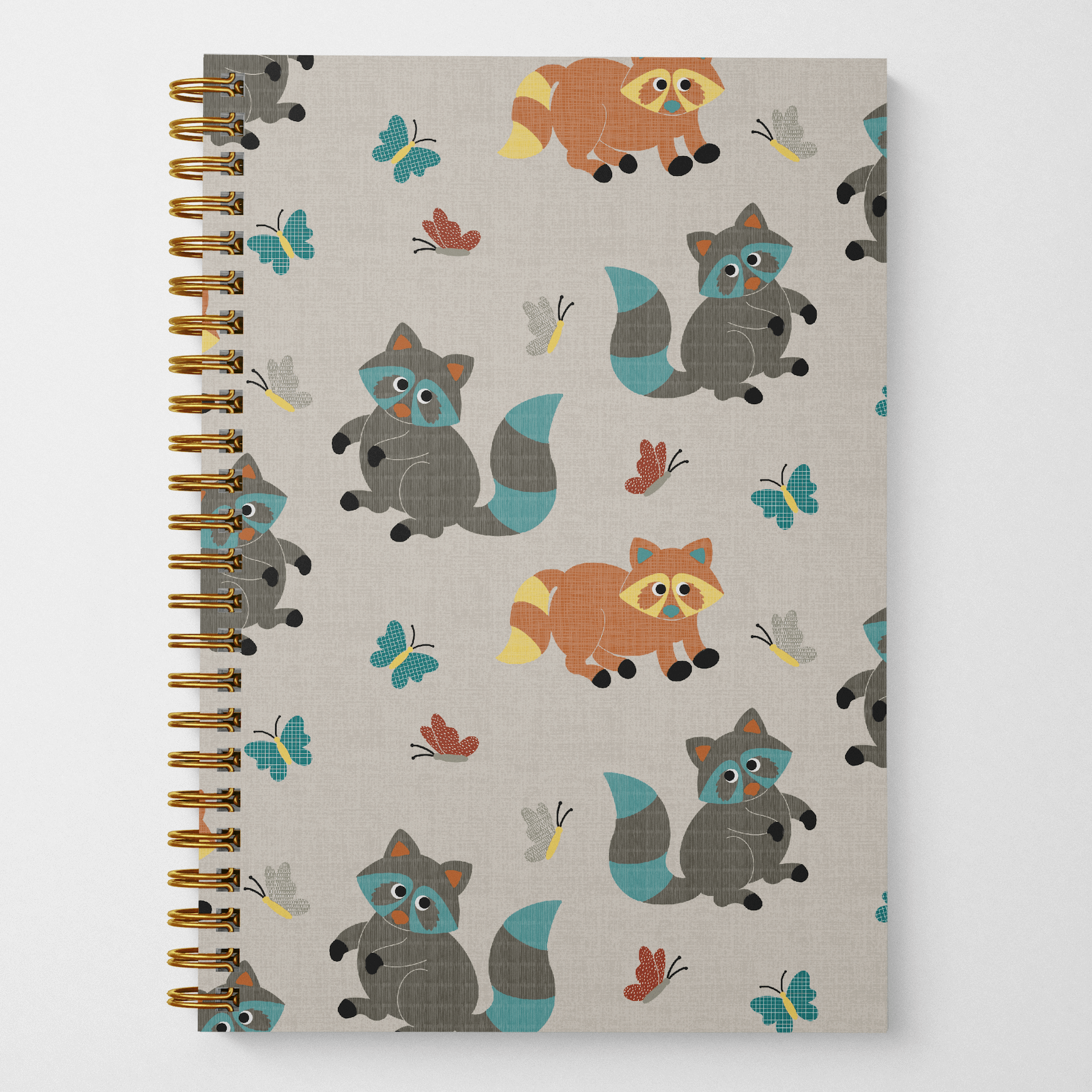A photo of the front cover of a wire spiral-bound 8.5" x 5.5" wire spiral-bound notebook with 60 lined pages featuring cute brown and grey raccoons playing with colorful butterflies in a tossed pattern on a gray background.