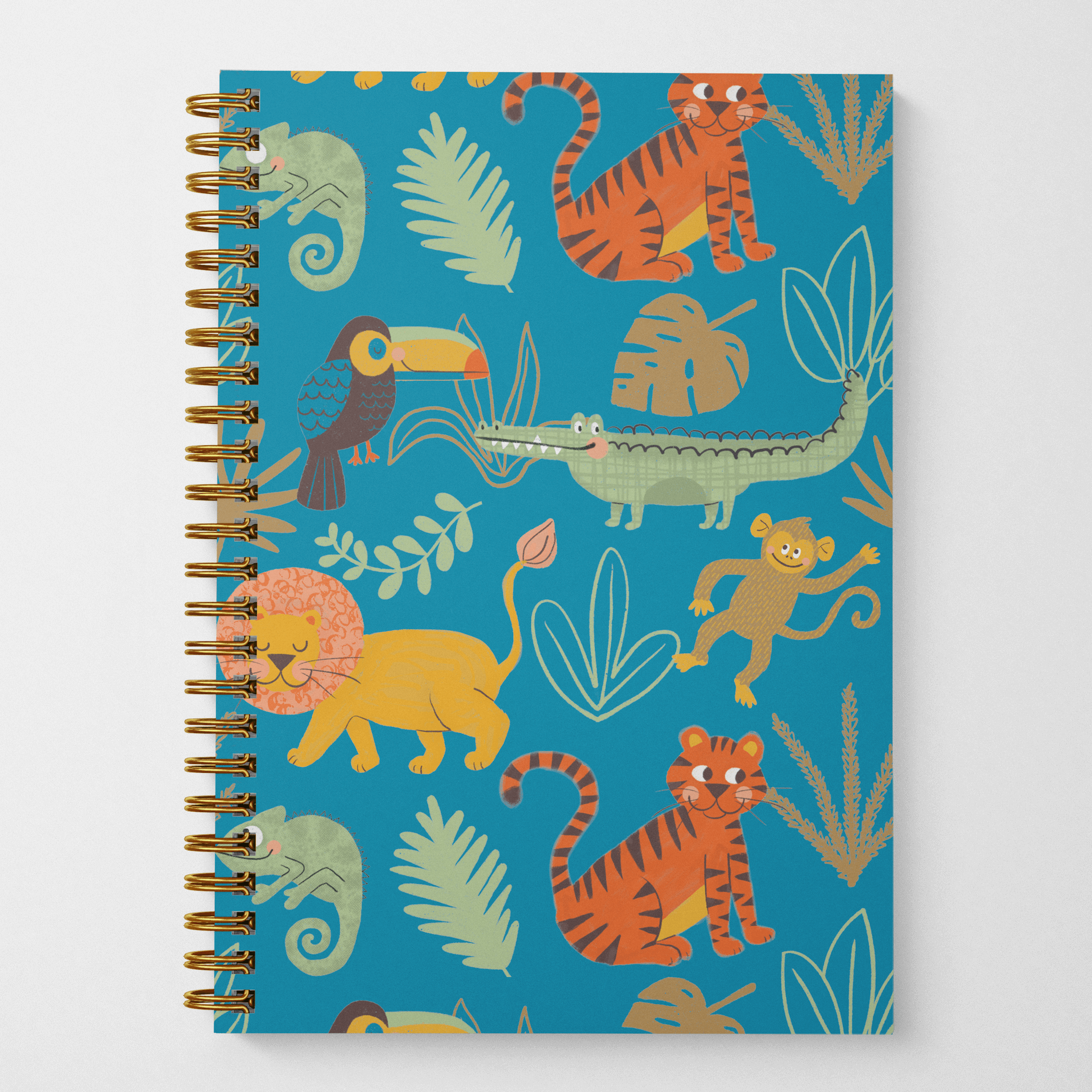 A photo of an 8.5" x 5.5" wire spiral-bound notebook featuring hand-illustrated cute jungle animals such as lions, tigers, toucans, iguanas, monkeys, and crocodiles on a bright blue background with green and brown leaves in a tossed pattern on the cover.