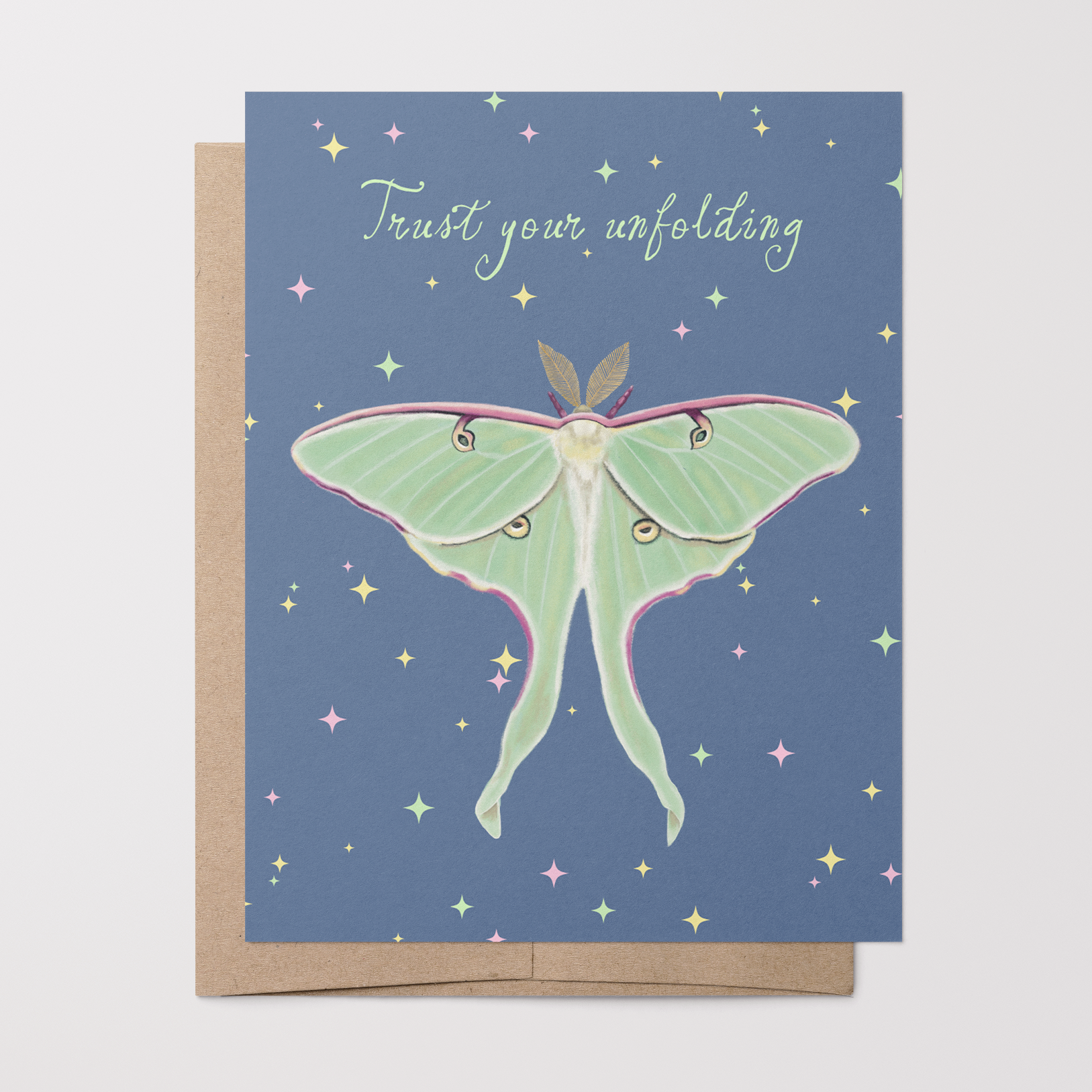 Greeting card with a Luna moth illustration and "Trust your unfolding" text on a blue background with colored stars on it.