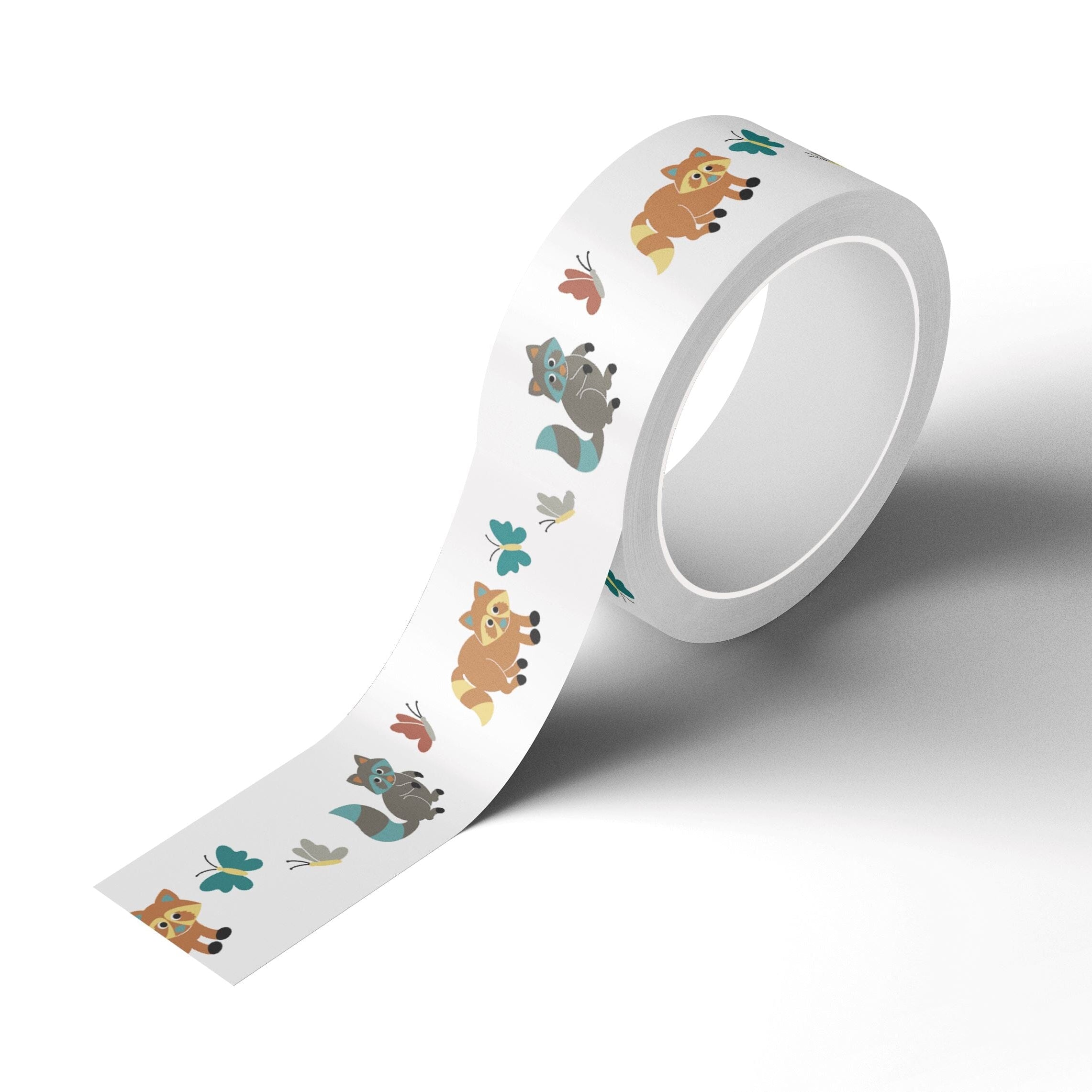 A roll of Japanese rice paper adhesive tape adorned with brown and gray raccoons and colorful butterflies on a white background.
