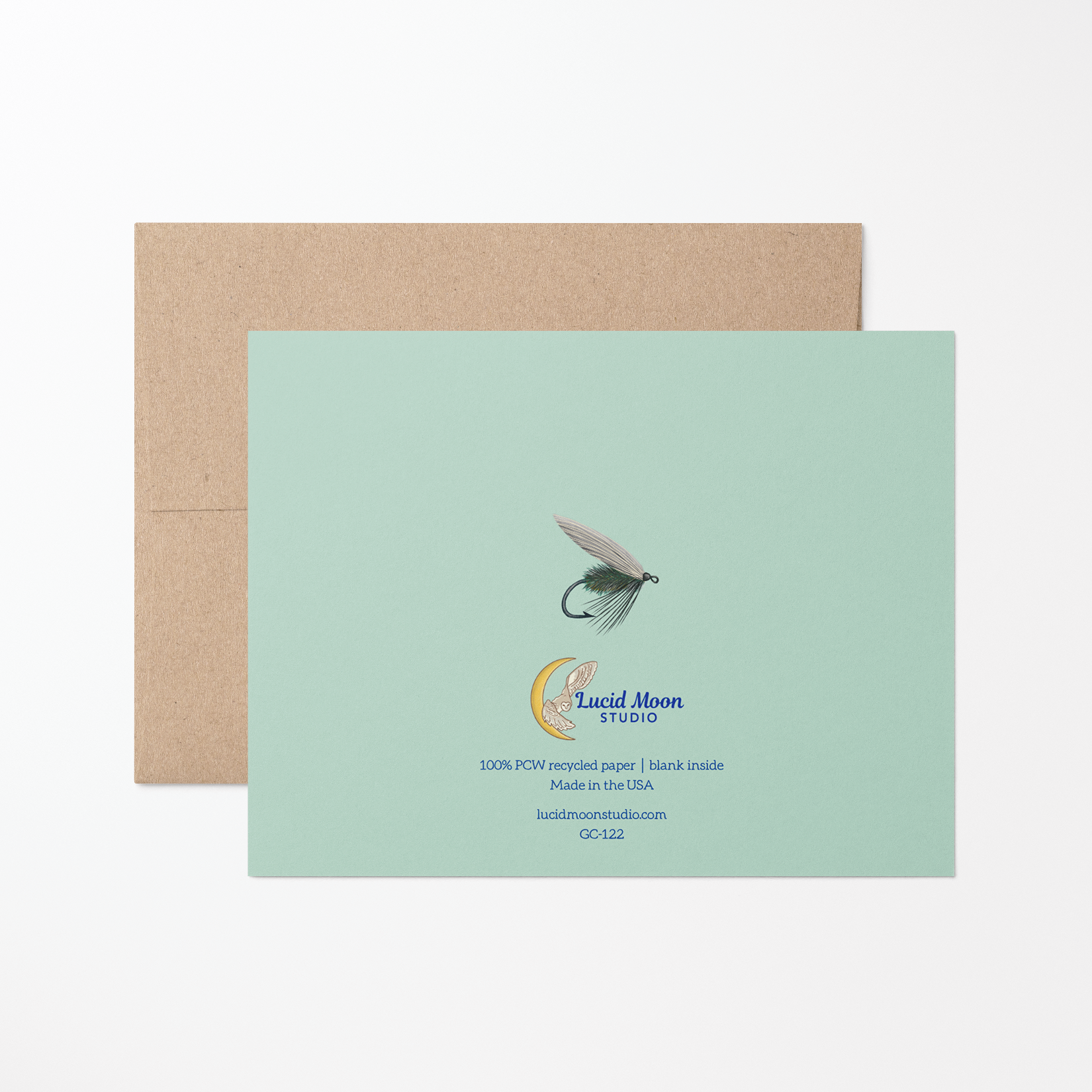 Back of greeting card with an illustration of a blue fishing fly, Lucid Moon Studio logo, website, and card information on a mint green background.