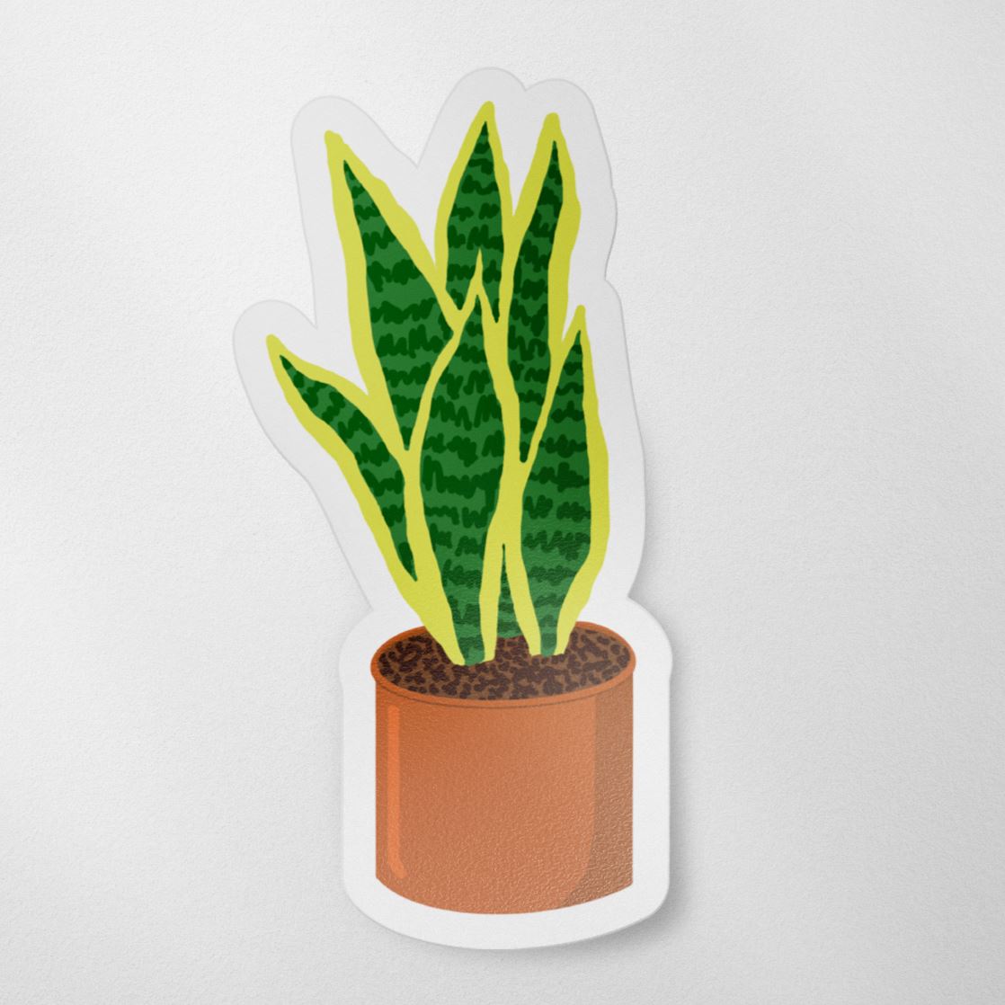Vinyl matte sticker with a hand drawn illustration of a green and yellow snake plant in an orange terracotta pot against a white background.