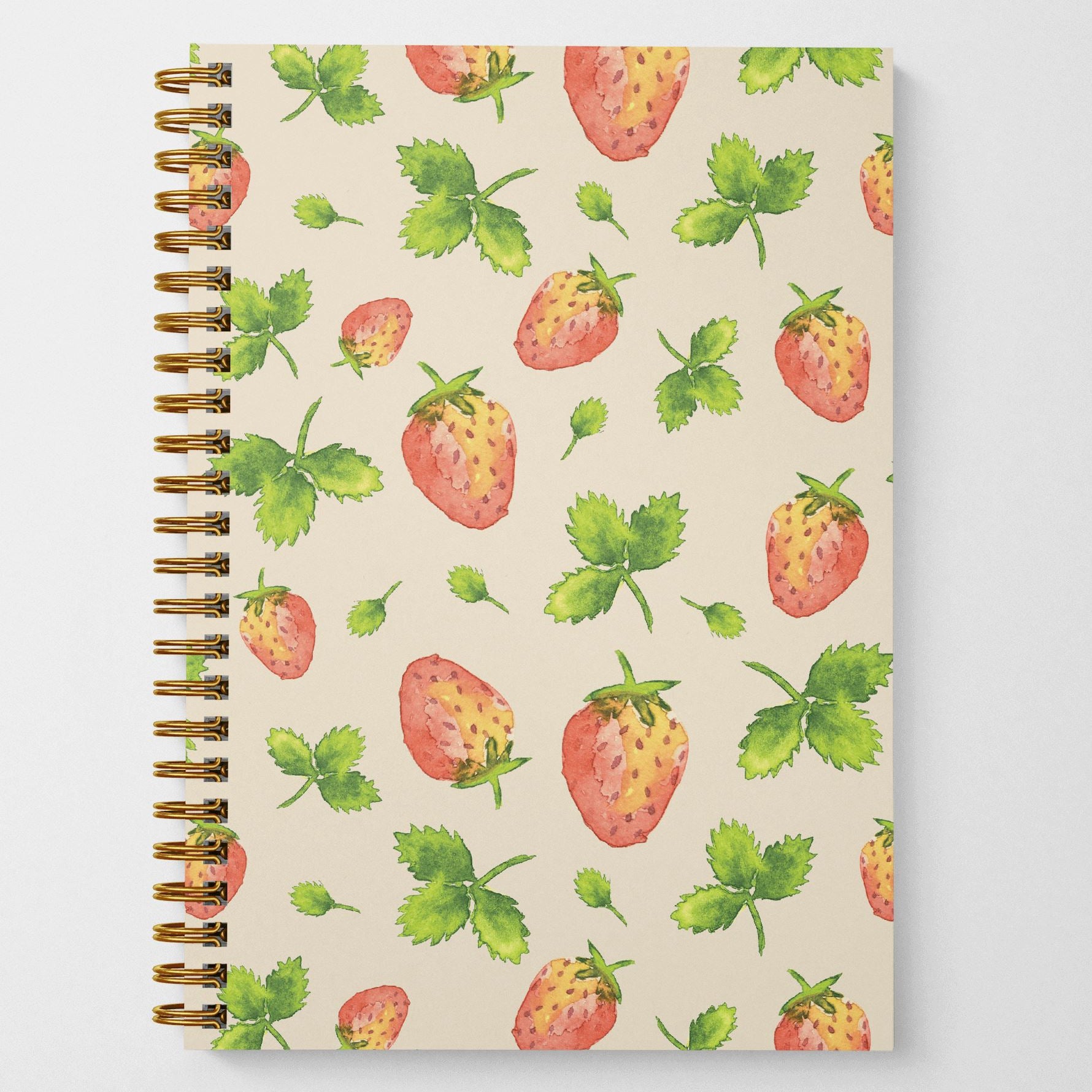A photo of the front cover of a wire spiral-bound notebook featuring watercolor-painted strawberries and leaves in a tossed pattern.