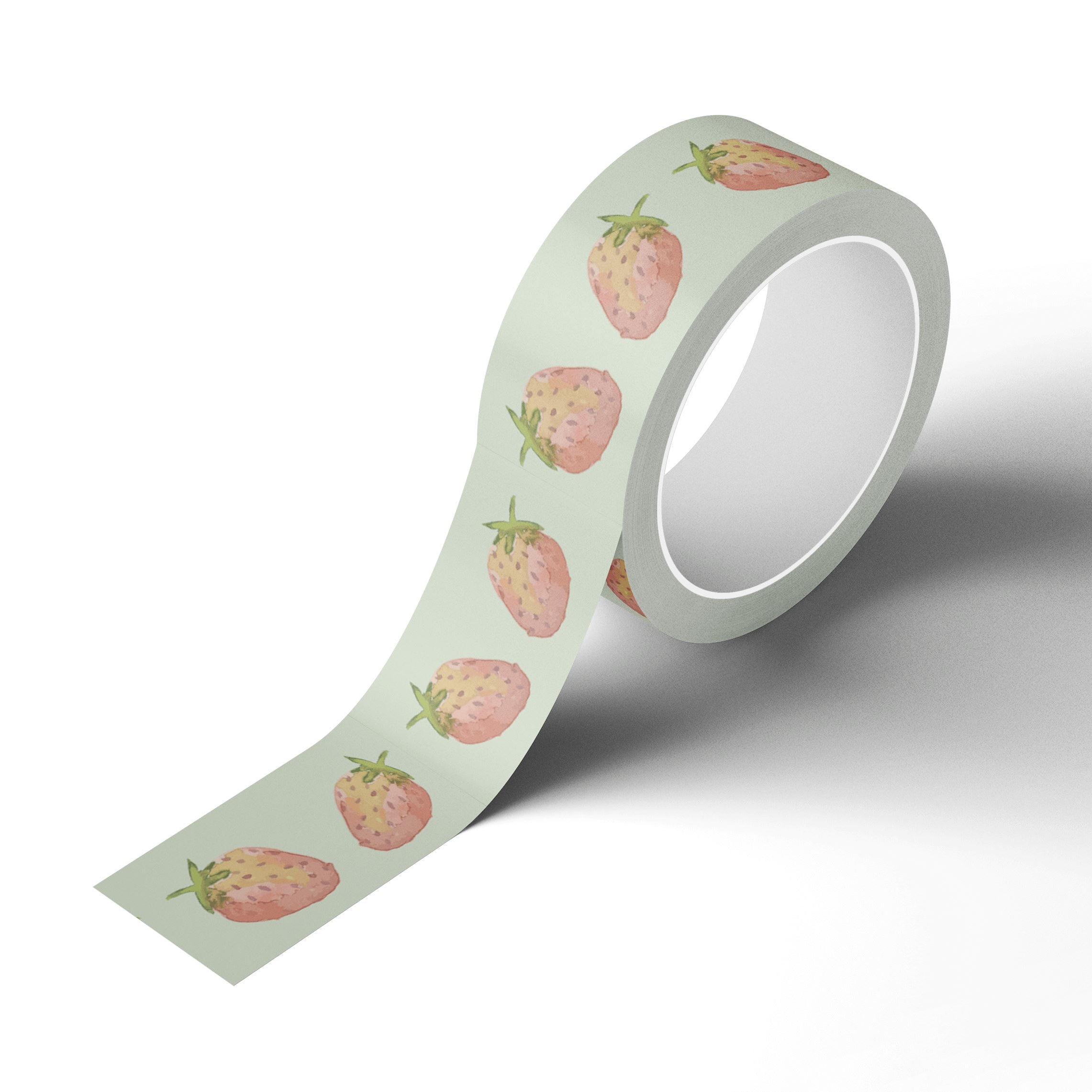 A roll of Japanese rice paper adhesive tape adorned with watercolor painted strawberries on it.