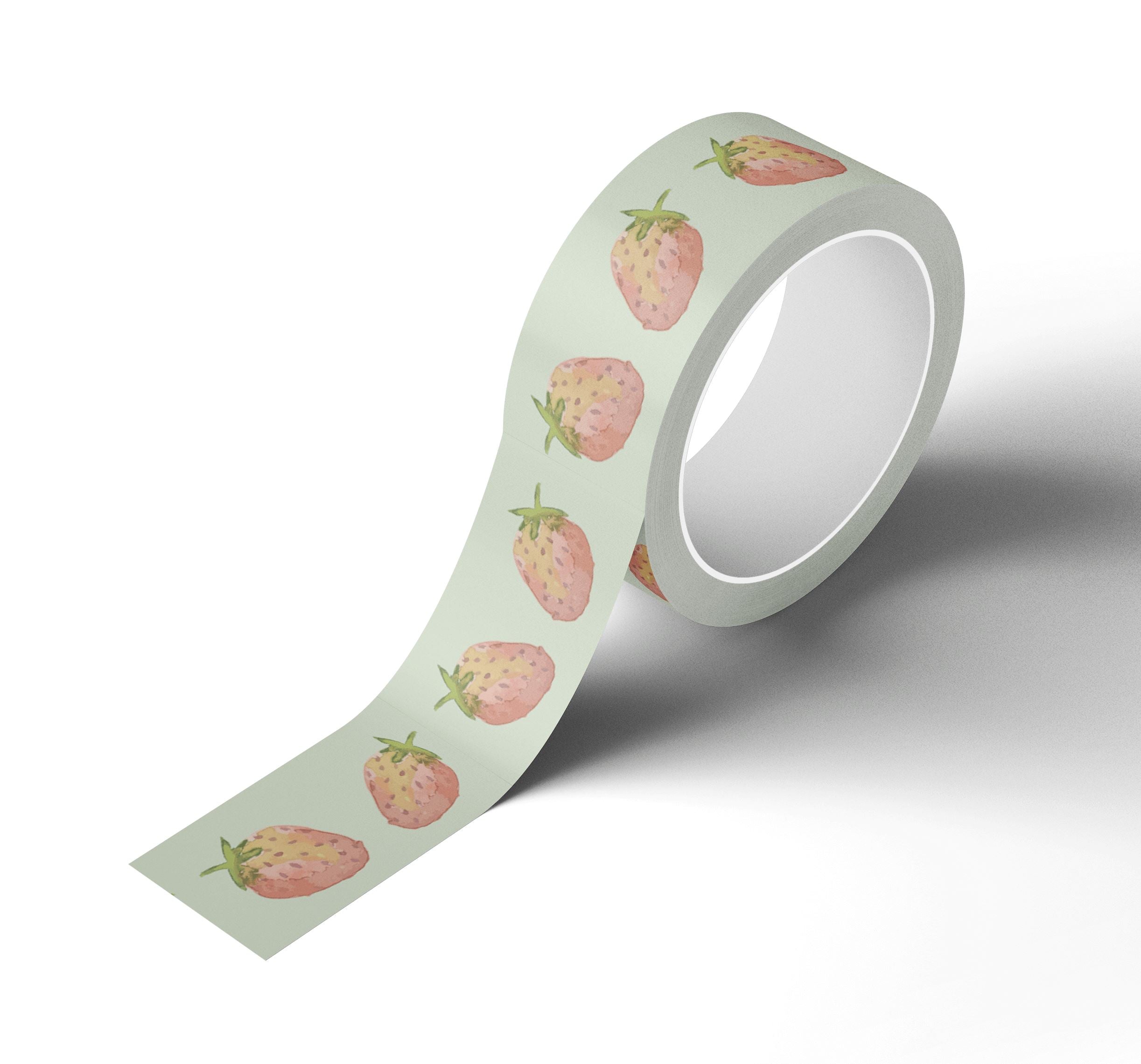 A roll of Japanese rice paper adhesive tape adorned with watercolor painted strawberries on it.