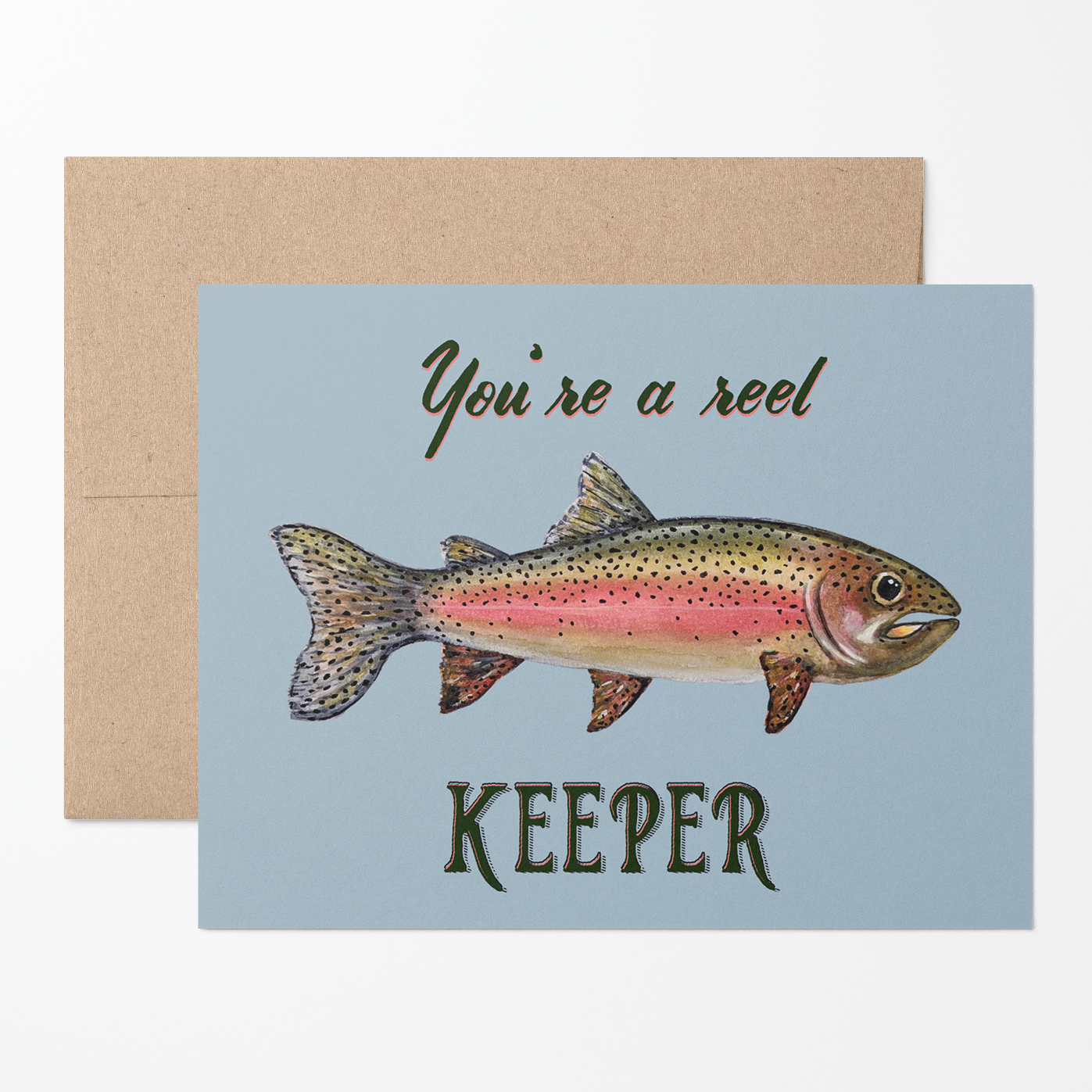 Greeting card with a watercolor rainbow trout illustration and text "You're a reel keeper" on a light blue background with a brown kraft envelope.