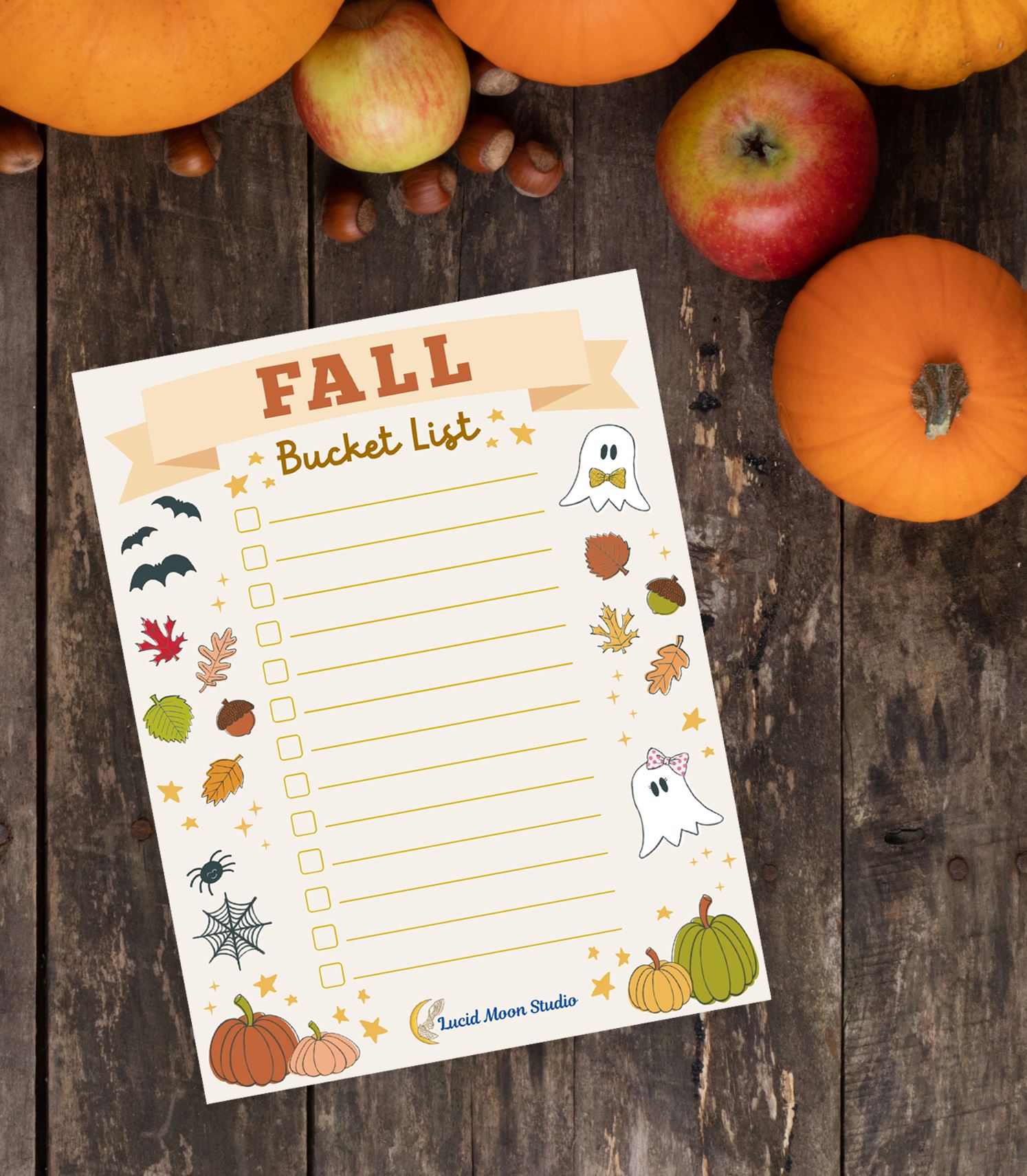 A free printable Fall Bucket List checklist page to fill in the activities you want to complete during the fall season. Decorated with fall and Halloween illustrations of leaves, acorns, bats, spider, pumpkins, and ghosts hand drawn by Lisa Petrillo