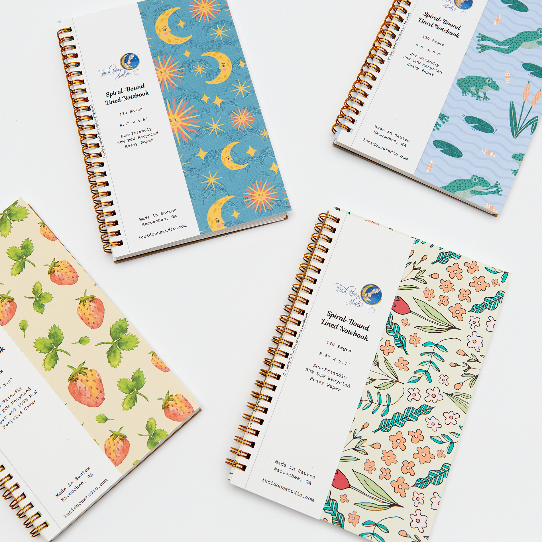 An assortment of spiral notebooks with lined pages and colorful nature-inspired covers on a white background