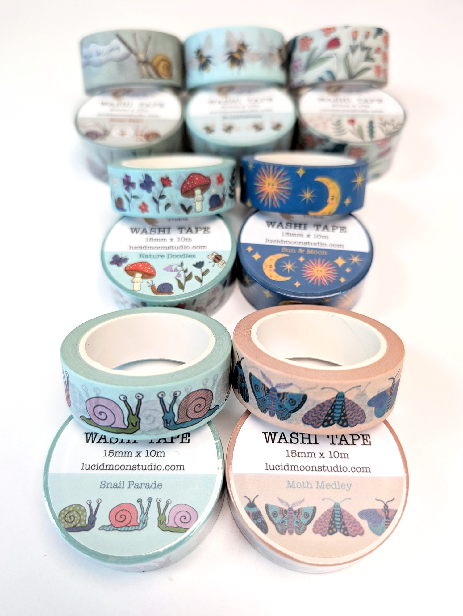 An assortment of colorful nature-inspired washi tape rolls on a white background