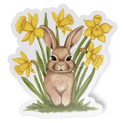Sticker of a rabbit among yellow daffodils on a white background