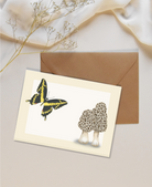 Mini card with a butterfly and morel mushroom illustration on a beige background with a brown kraft envelope.