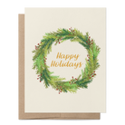 A holiday greeting card with a watercolor green wreath and gold 'Happy Holidays' text, shown with a brown kraft envelope on a white background.