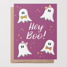 Halloween-themed greeting card with hand-drawn ghosts and 'Hey Boo!' text on a purple background with a brown kraft envelope.
