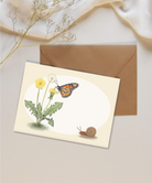 Blank mini card featuring a monarch butterfly and dandelions on a white and tan background with a brown kraft envelope.