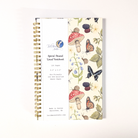 Notebook with nature-themed design including butterflies, mushrooms, snails, berries, and frogs on a white background