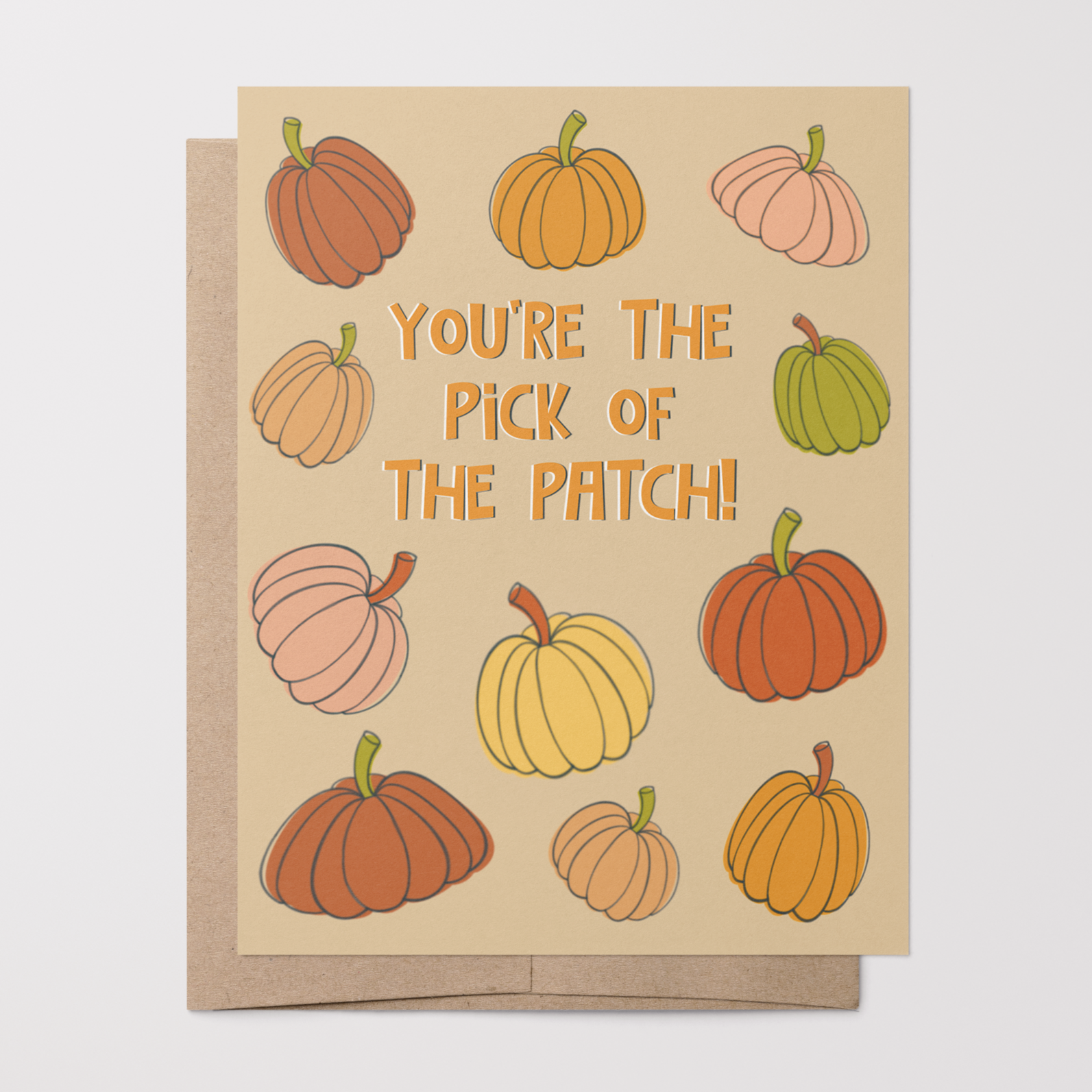 Greeting card with pastel hand-drawn pumpkins and text 'You're the pick of the patch!' on a beige background with a brown kraft envelope.