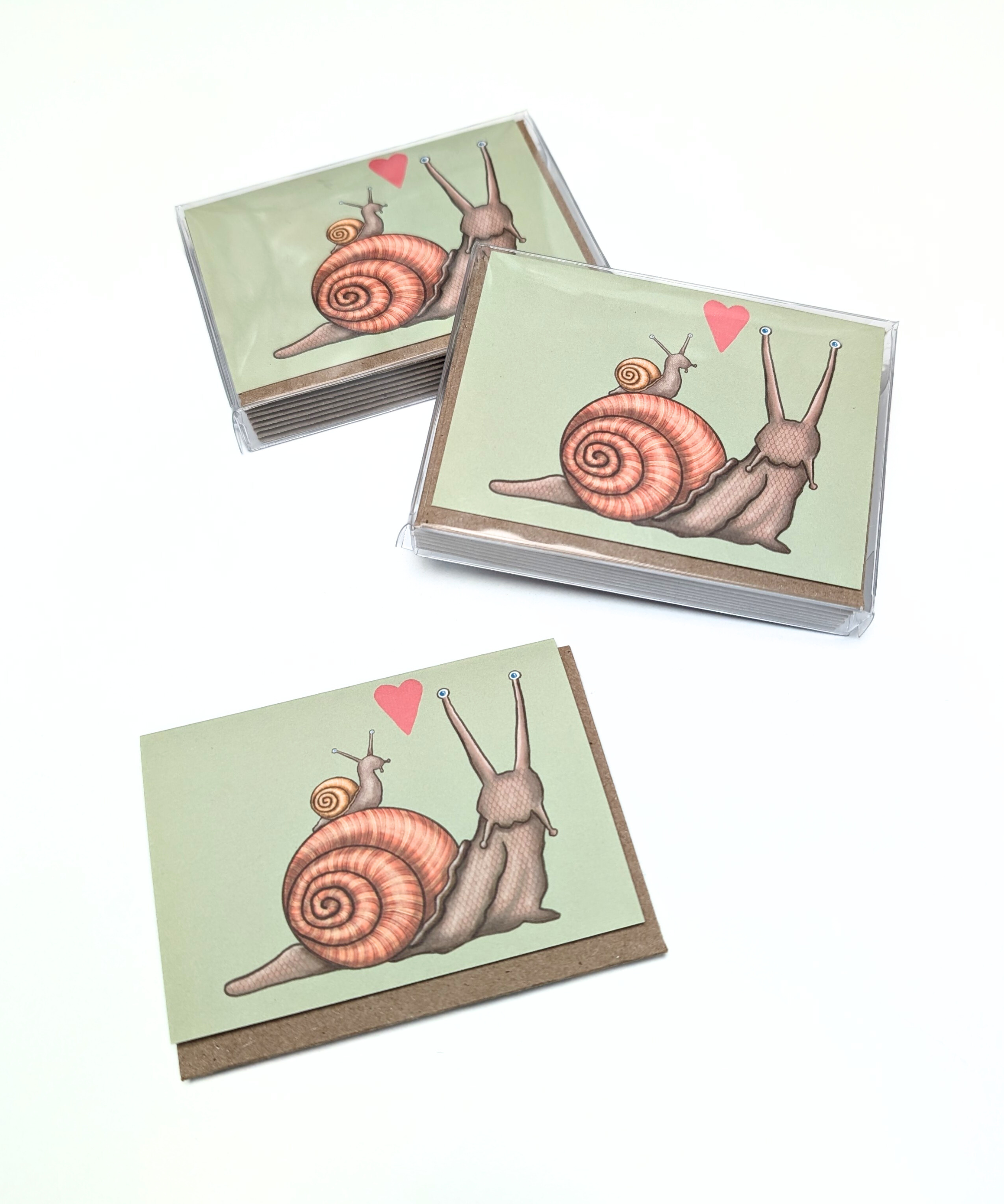 Boxed set of 8 snail-themed mini cards with kraft envelopes. Four different card designs.