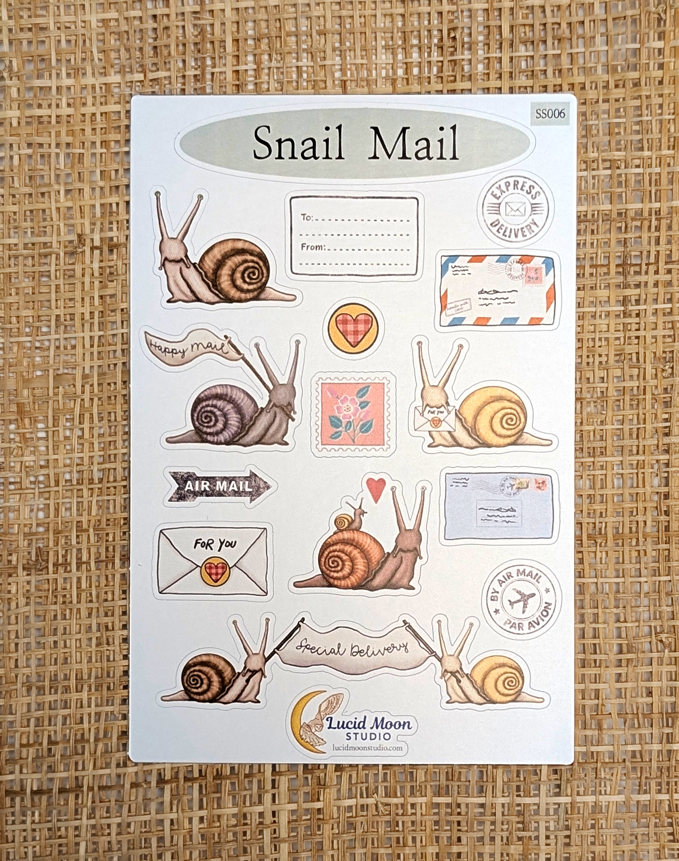 Sticker sheet with 16 individual journal stickers of hand-drawn snails and postage illustrations