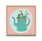 Framed artwork of a teal teapot with flowers on a pink background