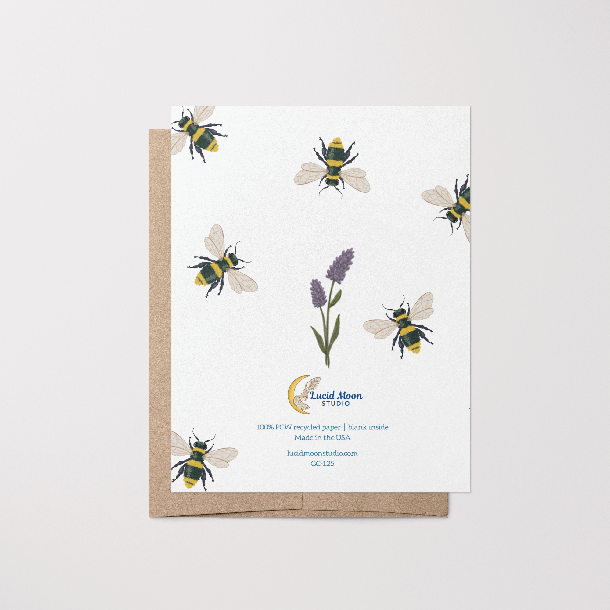 Back of greeting card with hand-drawn bee illustrations and a sprig of lavender with Lucid Moon Studio logo, website, and card information on a brown kraft envelope.