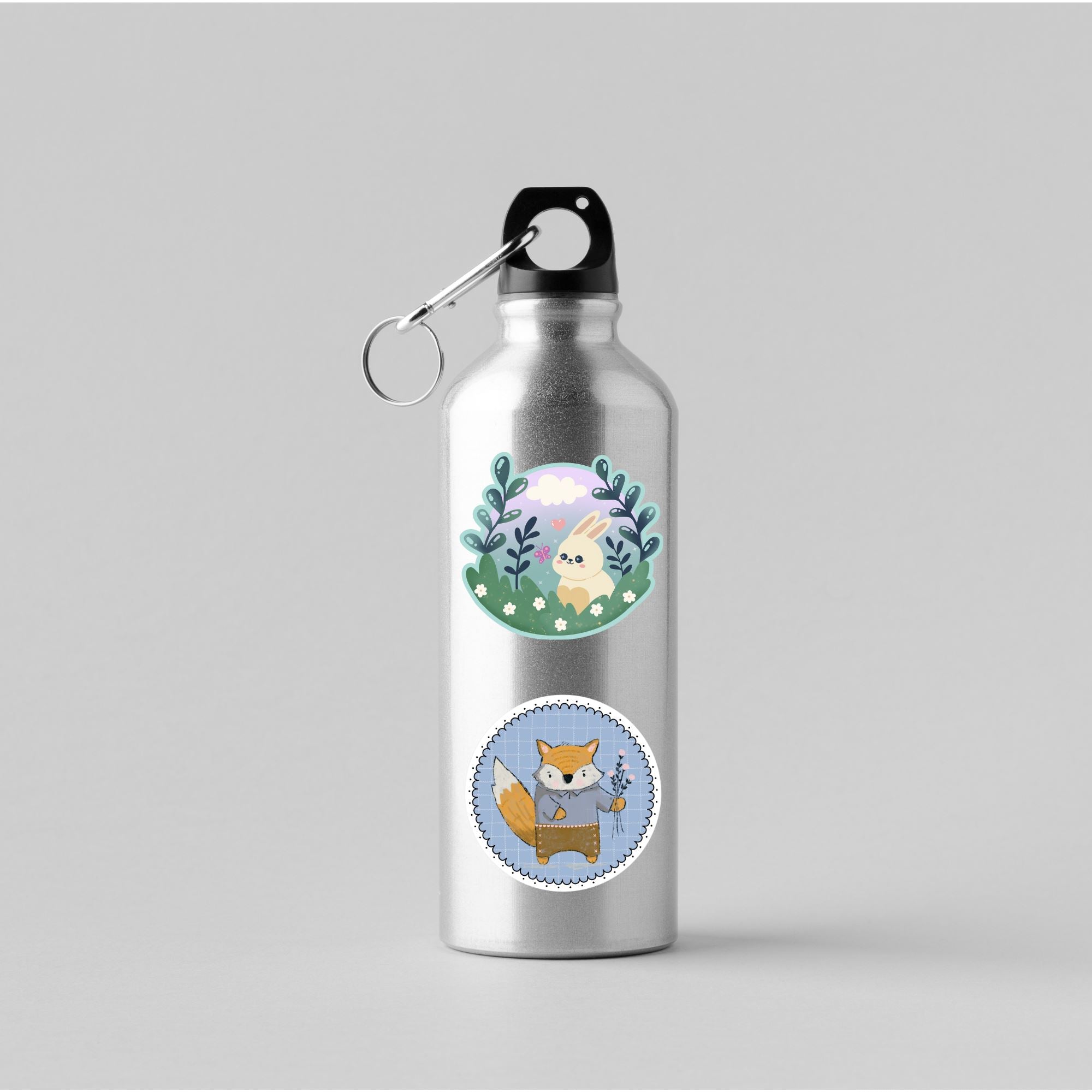 A silver water bottle with kawaii bunny in a meadow and raccoon holding flowers matte vinyl die cut stickers on it.