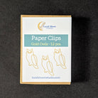 A small rectangular box of paper clips from Lucid Moon Studio, labeled 'Paper Clips Gold Owls - 12 pcs', placed on a dark textured background.
