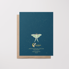 Back of greeting card with a luna moth illustration on a blue background with stars featuring the brand "Lucid Moon Studio," website, and card information.