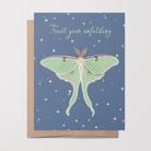 Greeting card with a Luna moth illustration and "Trust your unfolding" text on a blue background with colored stars on it.