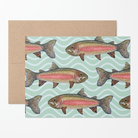 Greeting card with a school of watercolor rainbow trout illustrations on a mint green wavy pattern background with a brown kraft envelope.