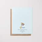 Back of greeting card with a hand-drawn fishing fly illustration, Lucid Moon Studio logo, website, and card information on a light blue background.