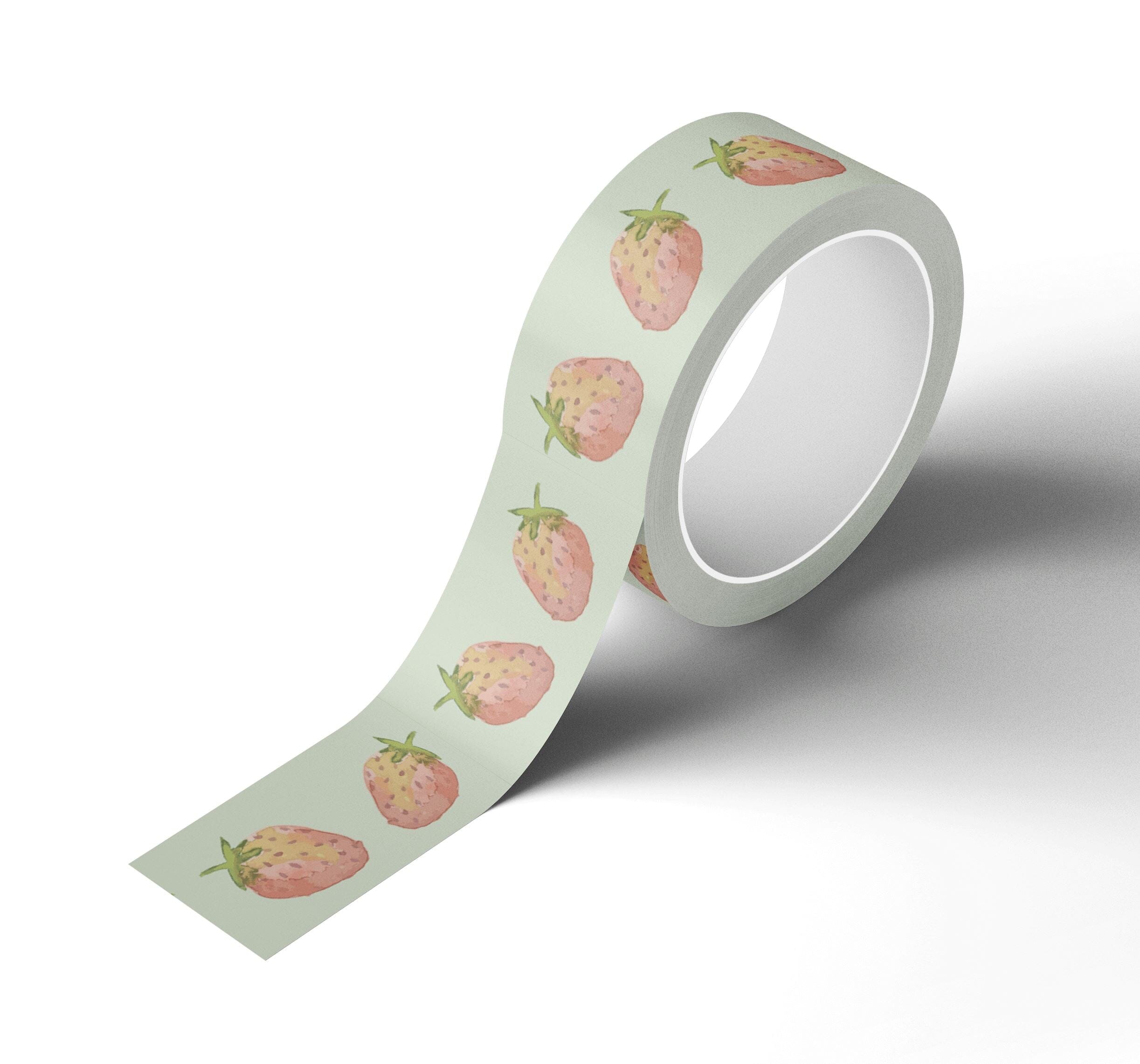A roll of Japanese rice paper adhesive tape adorned with watercolor painted strawberries on it.