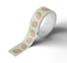 A roll of Japanese rice paper adhesive tape adorned with watercolor painted strawberries on it.